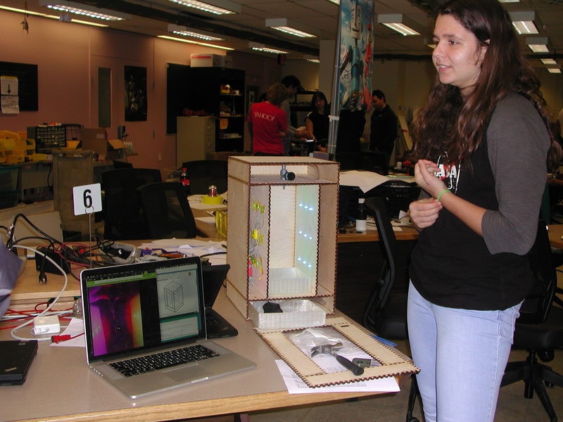 Freshman Francisca Vasconcelos displays the inner components of her final project, a levitating droplet fountain.