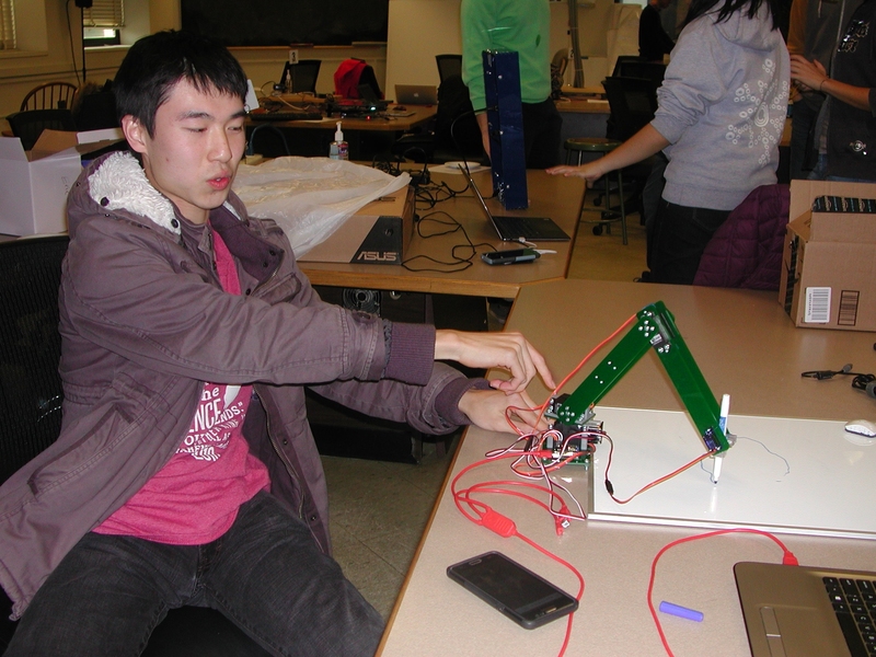 Freshman Lujing Cen demonstrates his final project, a digital automaton.