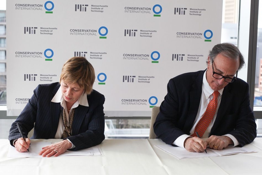 Maria T. Zuber, vice president for research at MIT, and Peter Seligmann, CEO of Conservation International, sign an agreement for a multiyear collaboration to develop and advance nature-based solutions to global climate change, through research, education, and outreach efforts.