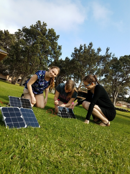 TREX participants Mikayla Murphy, Lily Dove and Tchelet Segev (l-r) attach a solar panel to a low-cost sulfur dioxide sensor.