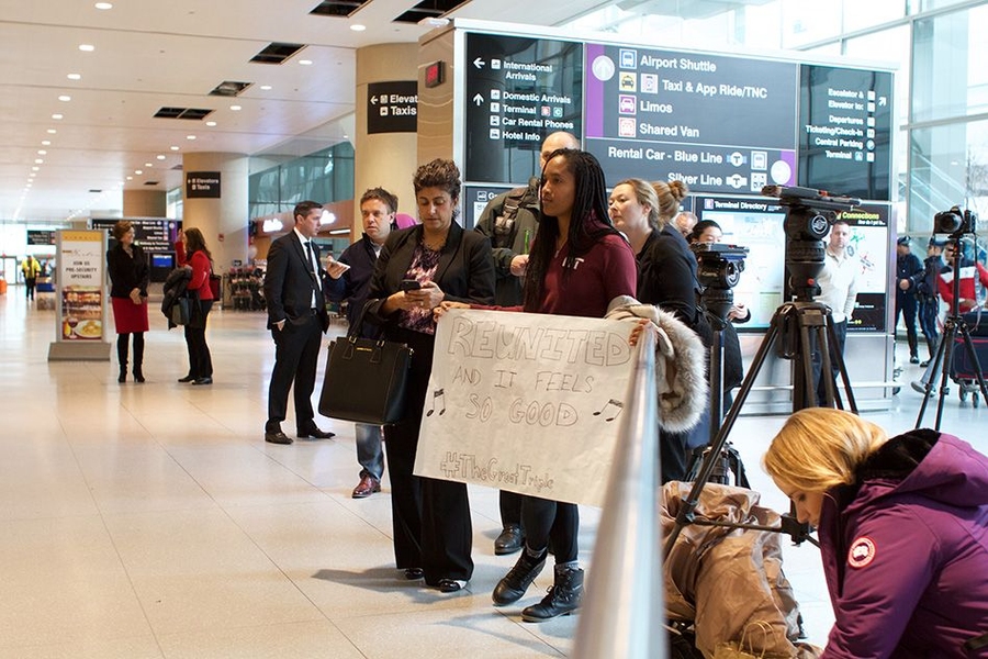 A roommate of one of the two MIT undergraduates initially denied re-entry to the United States, along with MIT officials, awaited the student's arrival at Logan Airport in Boston on Friday afternoon.