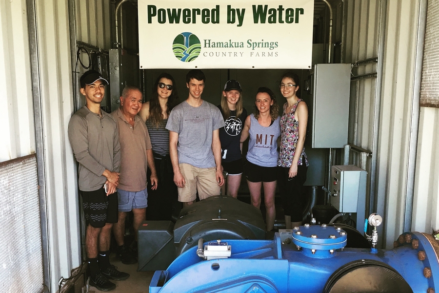 Richard Ha (second from right), farmer and Hawaii native, shows MIT TREX participants how he generates his own electricity using water.