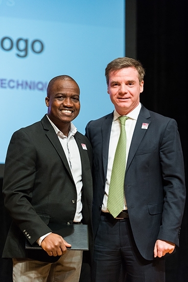 Executive Vice President and Treasurer Israel Ruiz presents Raoul Ouedraogo with an award for Bringing out the Best. 