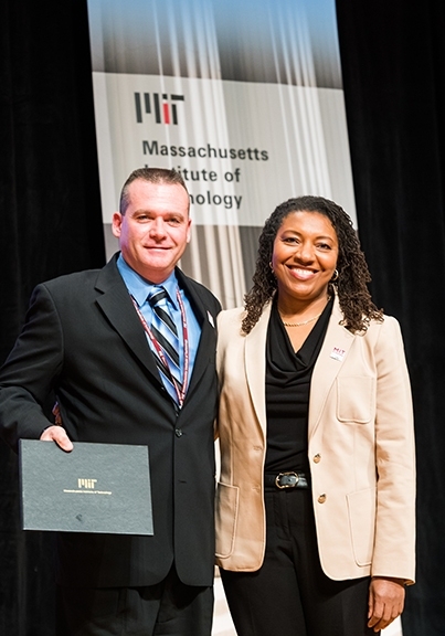 Lorraine A. Goffe, vice president for human resources, presents Jonathan Byford with an award for Outstanding Contributor.