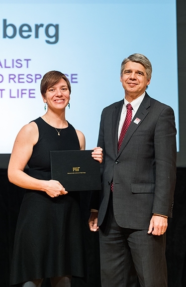 Eric Evans, director of Lincoln Laboratory, congratulates Vienna Rothberg, MIT Excellence Award winner in the category of Outstanding Contributor.