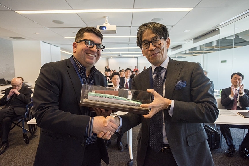Atsushi Yokoyama, director of the Technical Center at JR East, exchanges gifts with Ali Jadbabaie, the new JR East Professor. As part of the partnership between JR East and MIT, staff members from JR East have studied and earned degrees from MIT, and interns from MIT have spent time working at JR East in Japan.