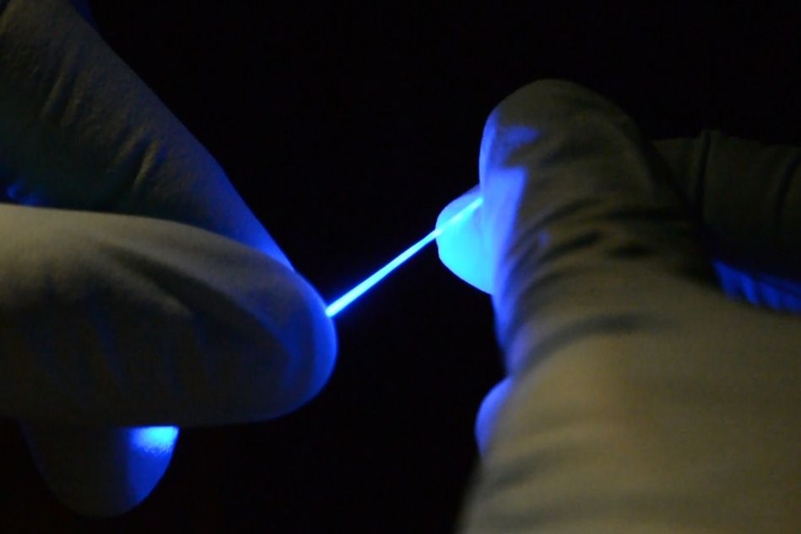 Researchers have developed a rubber-like fiber, shown here, that can flex and stretch while simultaneously delivering both optical impulses, for optoelectronic stimulation, and electrical connections, for stimulation and monitoring.