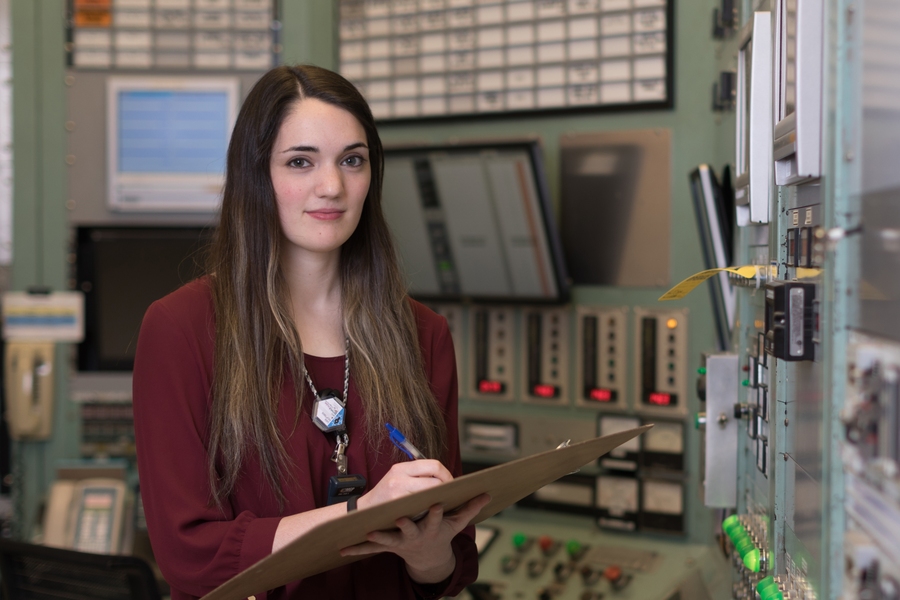Sara Hauptman stands in the control room of MIT's Nuclear Reactor Lab.