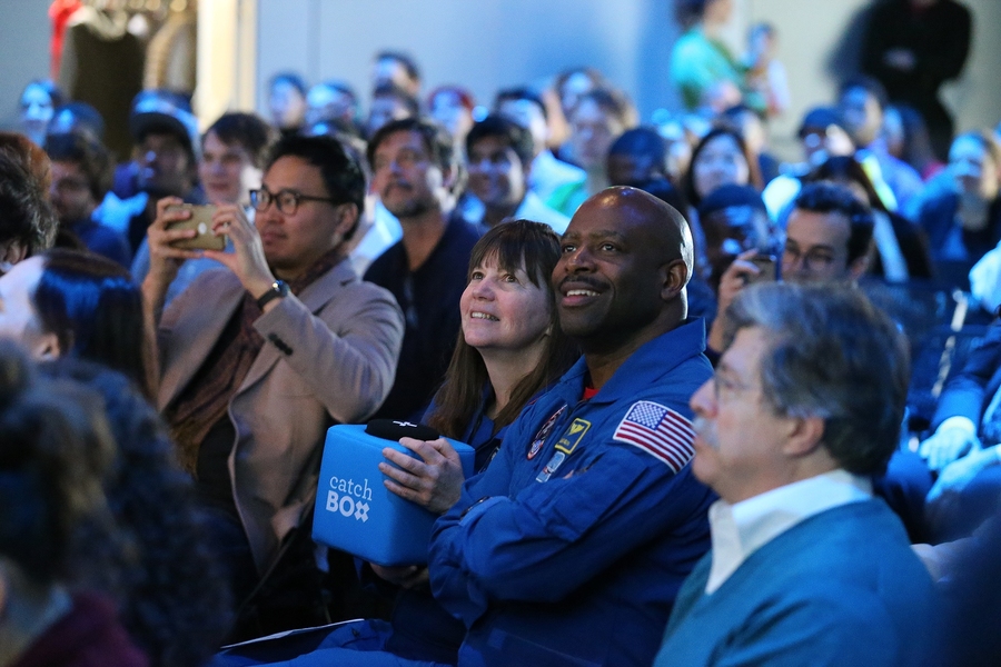 Astronauts Cady Coleman and Leland Melvin hold the microphone “catch box” that audience members threw around for asking questions at the March 12 event.
