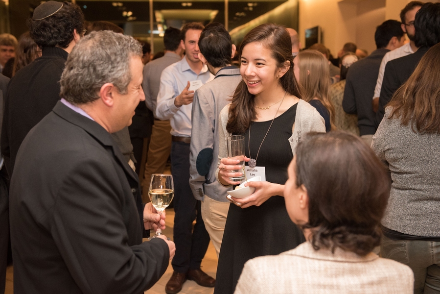 Guests mingle at a reception ahead of the program.