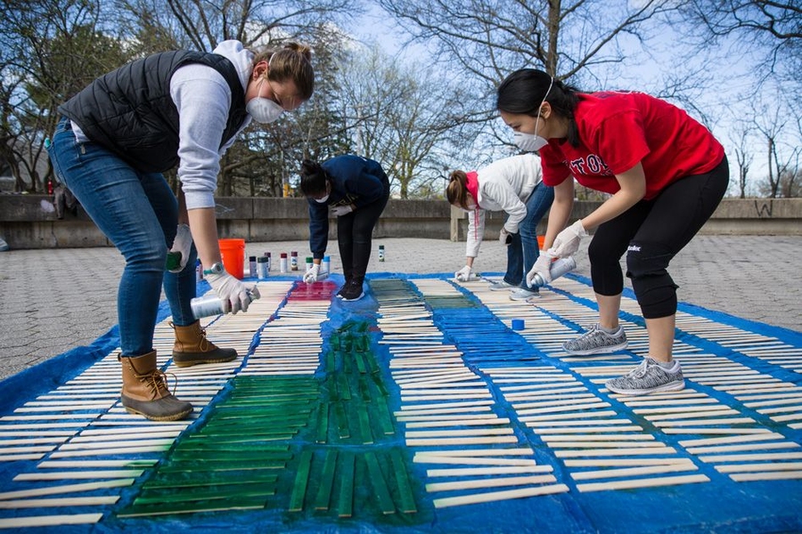 “Together in Service gives the MIT community the opportunity to see some of the vital work that Cambridge and Boston-area nonprofits are doing, and to make a personal contribution to their efforts,” said Kate Trimble, co-chair of Together in Service Day and director of the Priscilla King Gray Public Service Center. Pictured, volunteers for CitySprouts spray paint stakes that children can plac...
