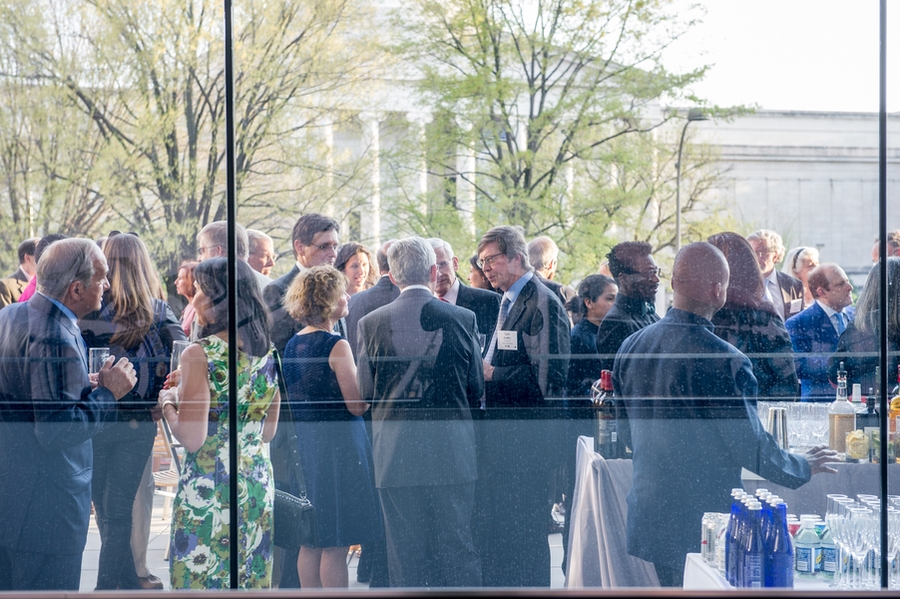 Guests mingle at a reception ahead of the program. 