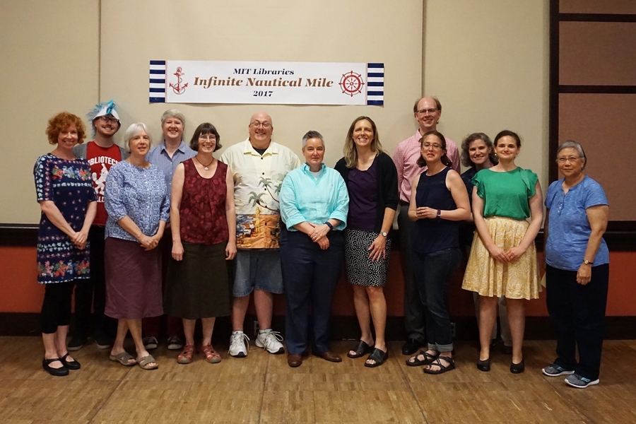 Chris Bourg (at center in turquoise blue shirt) stands with the recipients of the MIT Libraries' 2017 Infinite Mile Awards.