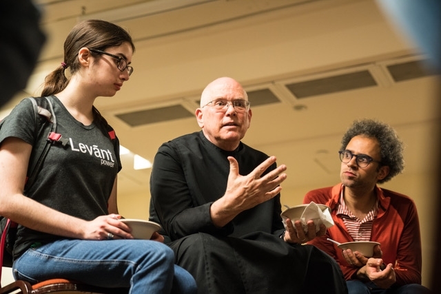 Brother David Vryhof meet with MIT students to answer questions about daily life at the monastery. Student Rachel Thornton listens, as does associate professor of anthropology Graham Jones. He organized the end-of-semester visit.