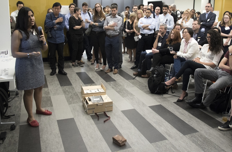 At a "pitch and demo" DesignX accelerator event, Department of Urban Studies and Planning student Riddhi Shah, lead for the Kumej project, makes her pitch to the crowd. Kumej is a light, collapsible seat designed to enable underprivileged students in India to carry and create their own comfortable work surface, whether at a construction site where their parents work or in a rural school.