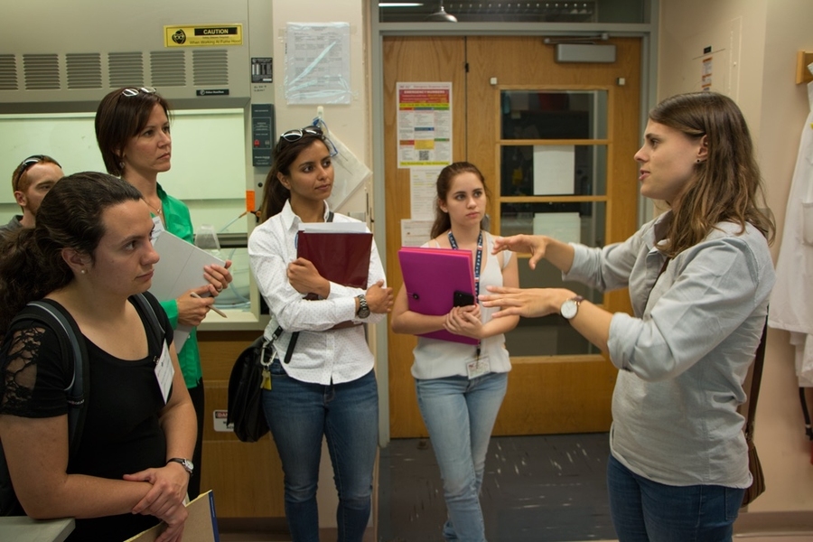 Mechanical engineering graduate student Caroline Wagner (right) explains equipment in the Ribbeck Lab for testing the microscopic mechanical properties of biological gels such as mucus, to 2017 MPC-CMSE Summer Scholars (l-r) Luke Soule, Alexandra Oliveira, Stephanie Bauman, Amy Duggal, and Gaetana Michelet.