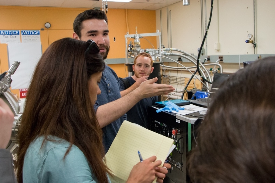 Electrical engineering and computer science graduate student Joseph Finley (center) explains research in the lab of Assistant Professor Luqiao Liu to Summer Scholars Amy Duggal (left) and Luke Soule. Finley uses processes such as electron sputtering and ion milling to make magnetic thin films.