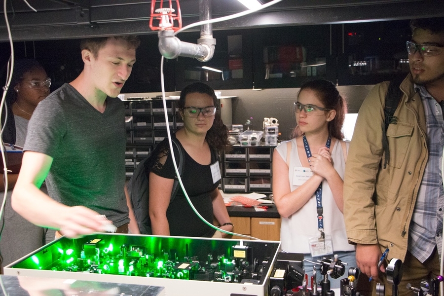 Chemical engineering graduate student Matt Ashner (left) explains laser lab bench experiments in the Tisdale Lab.