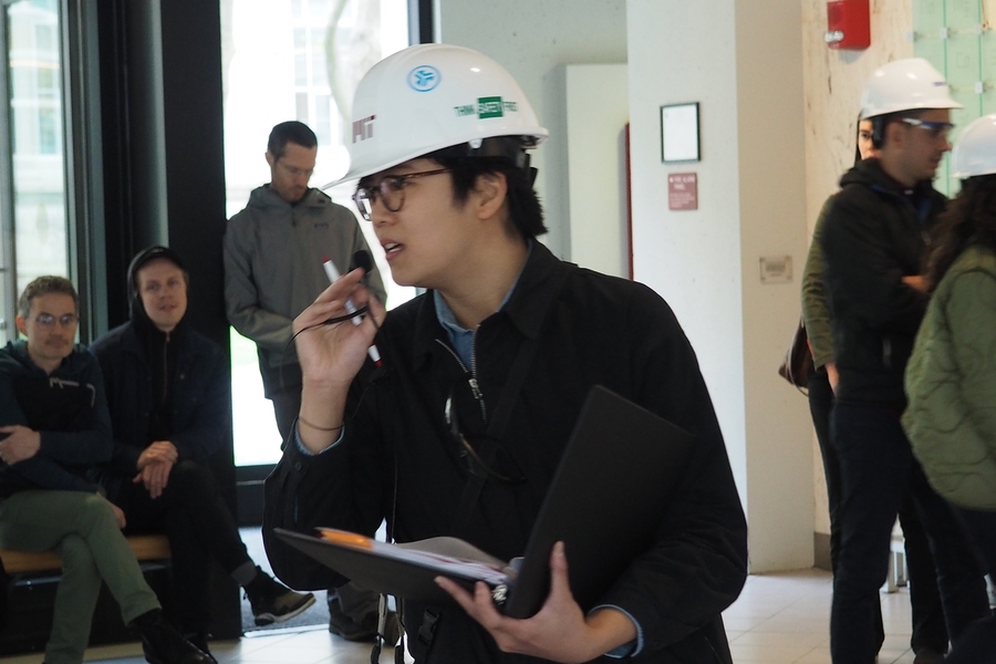 Program in Art, Culture, and Technology graduate student Angel Chen welcomes attendees to her thesis presentation in Building 18.