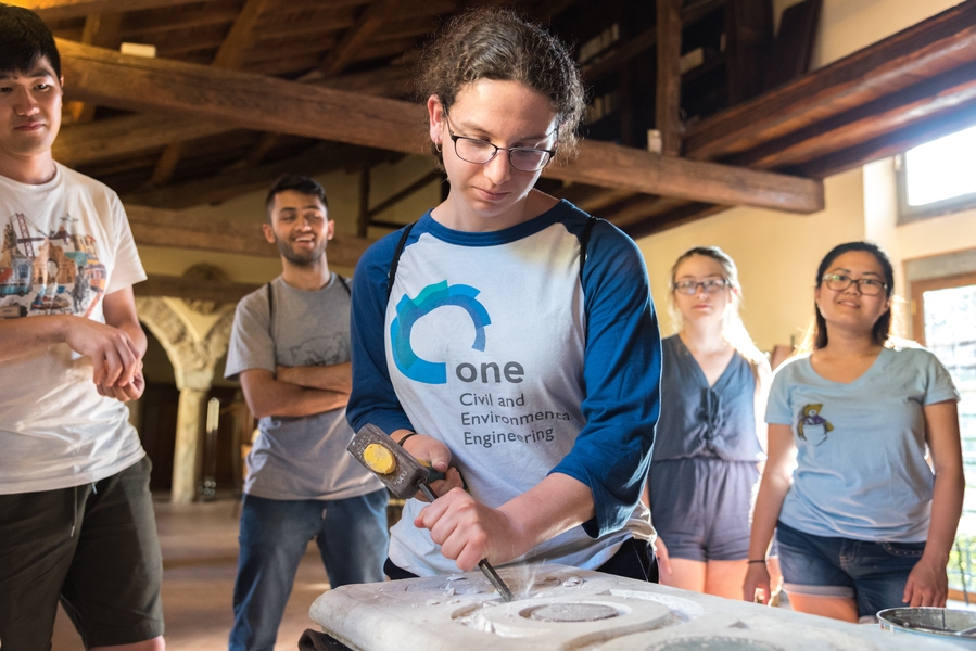 Brenda Stern ’17 carves marble with a mallet and chisel, traditional Italian tools, during the MIT Materials in Art, Archaeology and Architecture program in Italy.