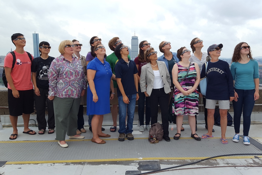 Department of Earth, Atmospheric and Planetary Sciences volunteers model their solar glasses before the on-campus viewing event.