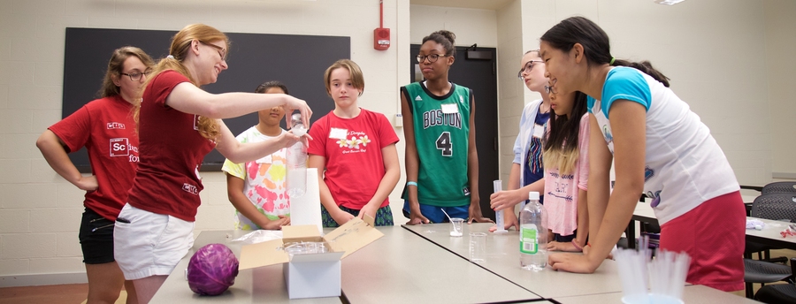 Women in Chemistry member Nicole Moody decants carbon dioxide into a bottle, which was later exposed to light to demonstrate how carbon dioxide retains heat in a small-scale version of the greenhouse effect.