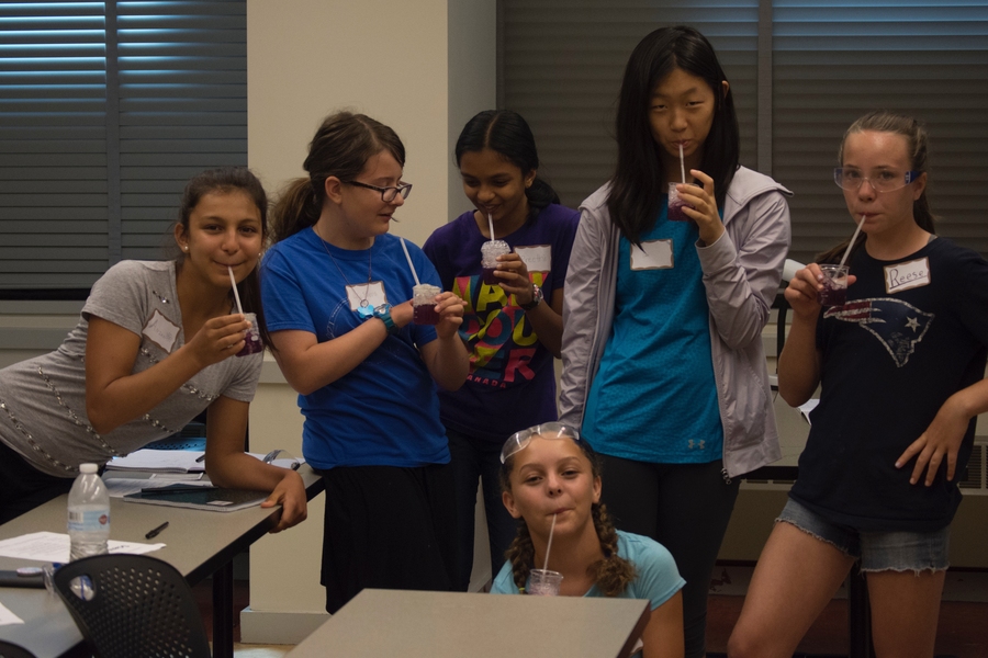 The girls blow bubbles into red cabbage juice (a home-made pH indicator) to investigate the effect of increased carbon dioxide levels on the pH of the ocean at the Environmental Science Experiment Station.