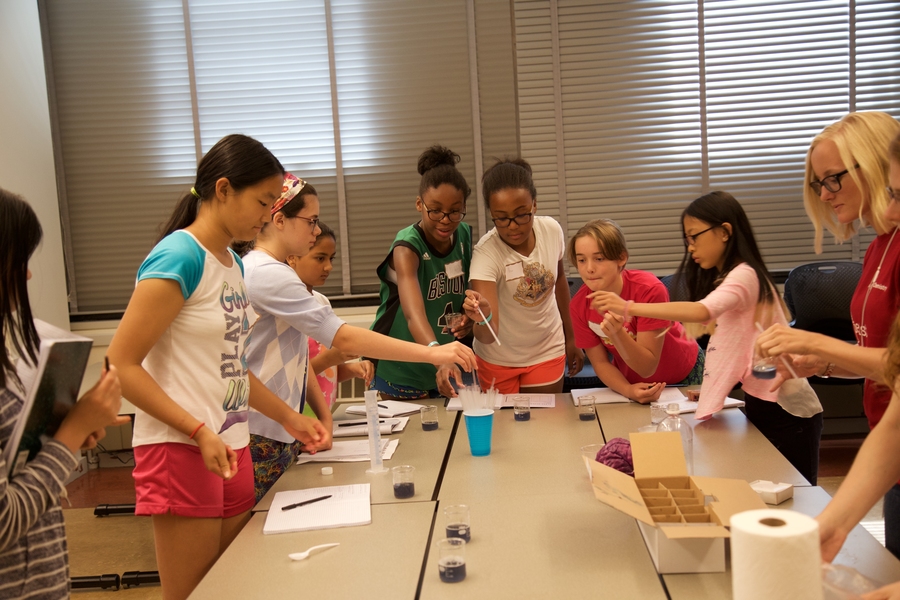 Participants select straws for the red cabbage juice experiment at the Environmental Science Experiment Station.