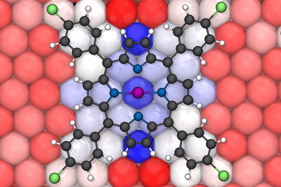 Density functional theory simulations of cobalt porphyrins on a copper surface exhibit strong charge transfer between the molecule and surface (red and blue atoms on surface) that influences electronic properties.