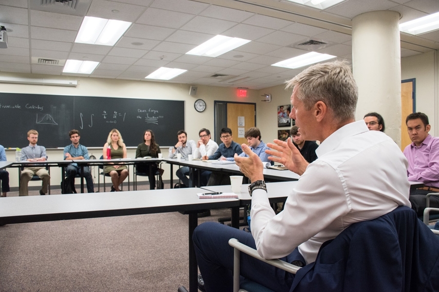 Student questions in the morning meeting with Brekelmans focused on carbon pricing, climate change, and long-range R&D planning.