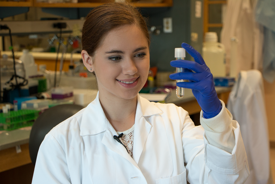 2017 MPC-CMSE Summer Scholar Gaetana Michelet looks at a vial in the Biogel Lab of Katharina Ribbeck, the Eugene Bell Career Development Professor of Tissue Engineering at MIT. Ribbeck studies how complex materials such as mucus influence bacterial behavior. 