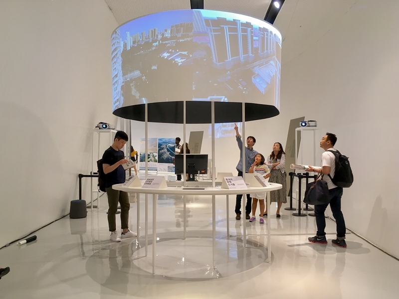Visitors at the Seoul Biennale interact with the "Ghost Cities" exhibition.