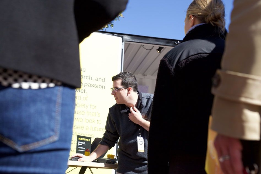 Student researchers, including graduate student Andrew Spielberg, pictured here, spoke with visitors about MIT technology ranging from a rubbery robot that identifies leaky pipes, to an ankle exoskeleton that gives walkers a boost.