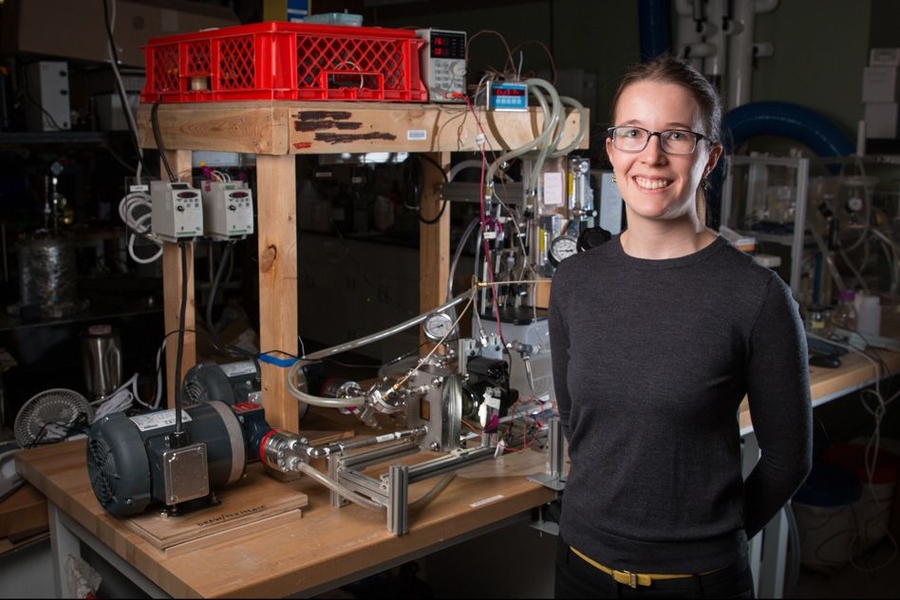 Emily Tow PhD '17, displays equipment she developed to measure the effects of different pressure levels on the way microorganisms build up on membranes used for desalinating water.