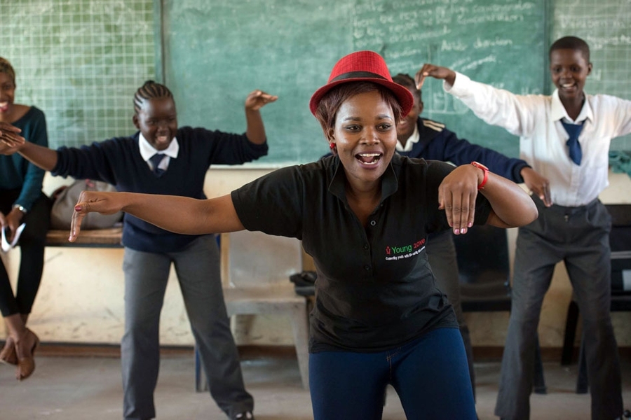 The non-profit Young 1ove designed a course for Botswana schools called “No Sugar” that teaches young girls the high likelihood of contracting HIV from older men called "sugar daddies." Classes begin with ice breakers, such as singing and dancing exercises (shown here). The remainder of the class teaches students risk factors associated with sugar daddies and how to seek help. The course has r...