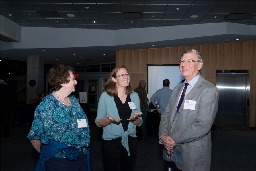 Kristin Bergmann sharing her research with EAPS alum Richard D. Rosen '69, SM '70, PhD '74, and Michelle Rosen during the reception.