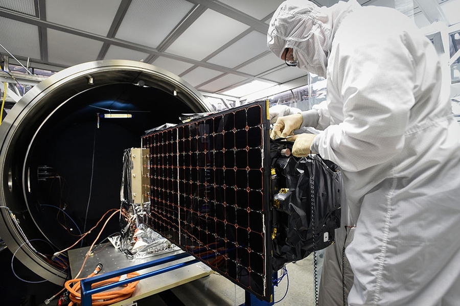 An engineer installs SensorSat, developed at Lincoln Laboratory, in the thermal-vacuum chamber used for testing the satellite's tolerance of conditions in space.