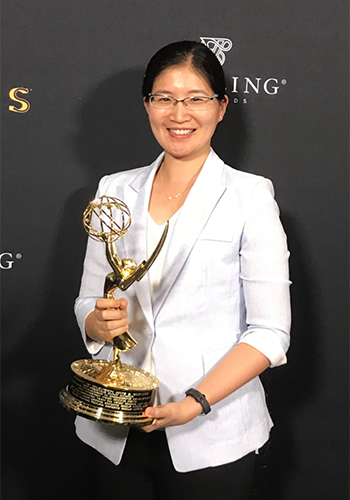 Vivienne Sze, who was part of a team that developed a new video-compression standard, holds an Engineering Emmy Award recognizing the group's work. 