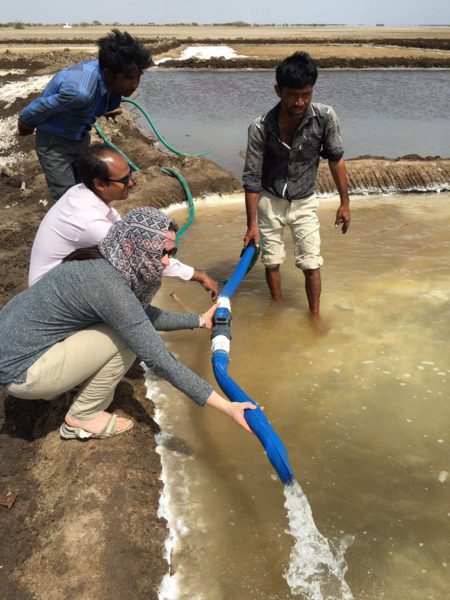 MIT and Technology Exchange Lab researchers examine a solar pump during a field visit in Gujarat, India.