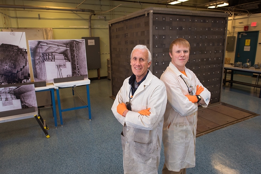 Kord Smith and NSE senior Micah Gale stand in front of the MIT graphite exponential pile, which will serve as a teaching and research tool for students. 