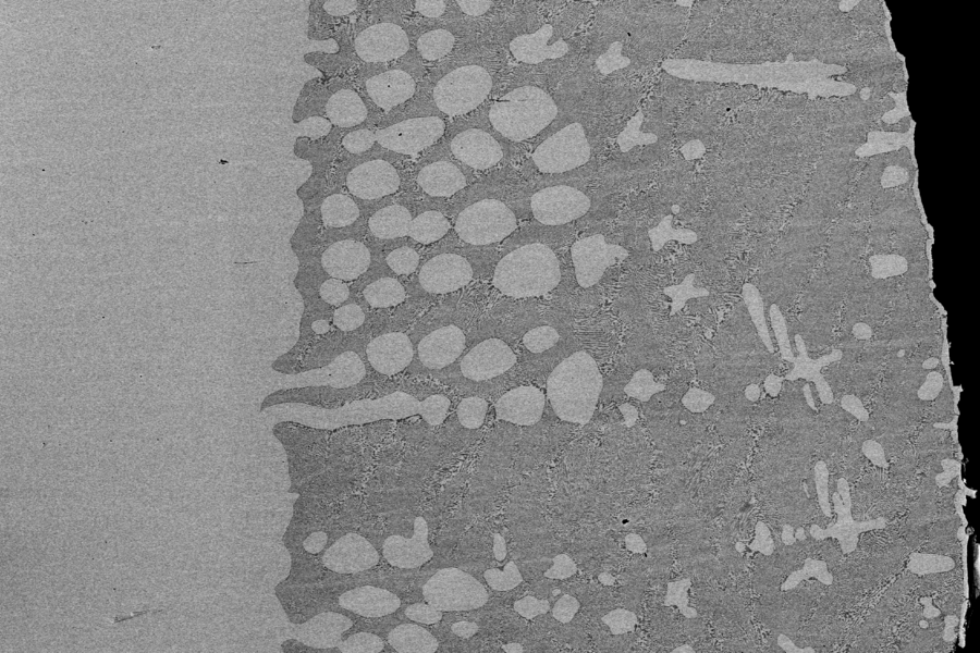 By adapting a thermal imaging furnace more commonly used for growing crystals, MIT graduate student Bradley Nakanishi melted an aluminum oxide rod and contacted the hanging liquid pendant that it formed with electrodes, enabling the decomposition by electrolysis of the material into oxygen gas and aluminum alloy for the first time. Here, a back-scattered electron micrograph shows the variation in ...