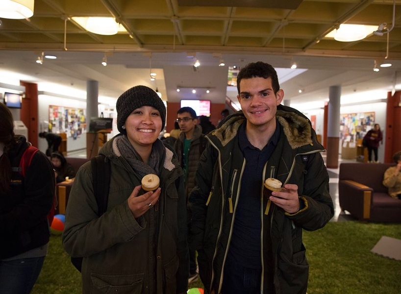 Members of the MIT community enjoy cupcakes on the indoor lawn.