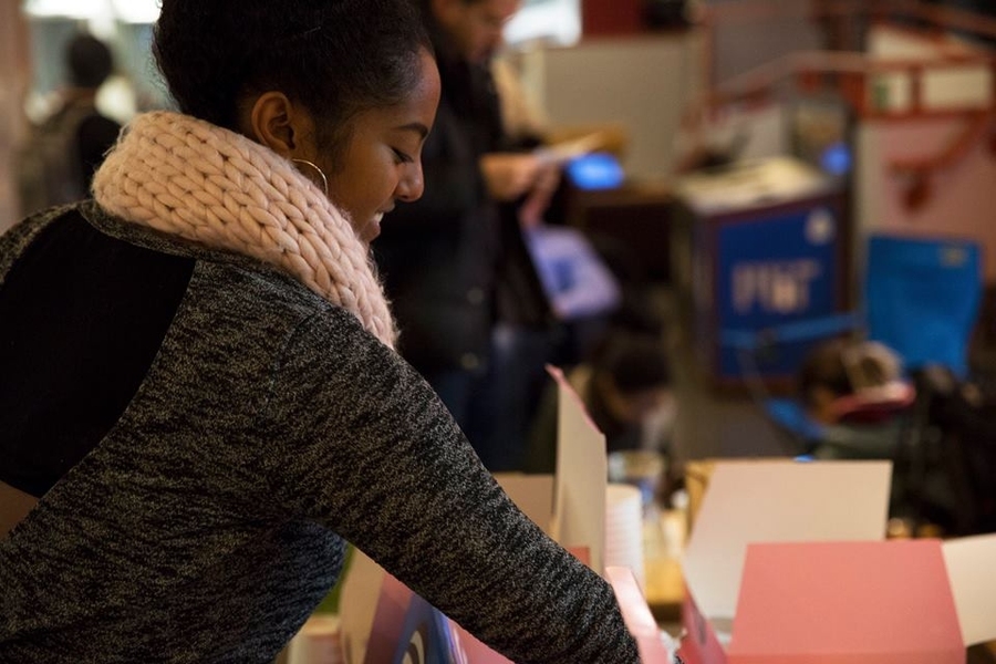 An MIT student enjoys cupcakes on the indoor lawn.