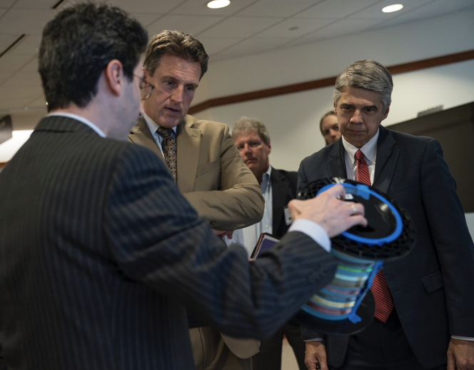At the event on Dec. 20, Sasha Stolyarov (left), principal investigator at the DFDC, demonstrated several advanced fibers technologies under development at the DFDC to Secretary Jay Ash (middle) and Eric Evans (right), director of Lincoln Laboratory.