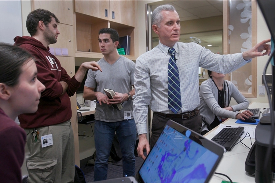 Mechanical Engineering students Elizabeth Mittman, Alban Cobi, and Luke Gray work with Piotr Zygmanski (right) at Brigham and Women's Hospital to design a phantom capable of precisely positioning radio-opaque markers in 3-D space, to verify the correct dose is being delivered spatially to the patient.
