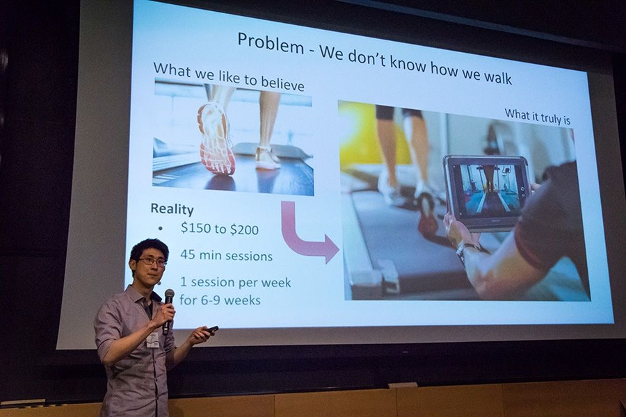 A team member from Kinematics delivers a pitch for smart shoe insoles that use sensors and real-time data to enable faster and more comprehensive gait analysis for physical therapists.