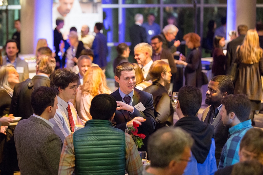Guests mingle at a reception, ahead of the event.