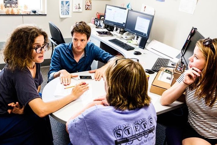 Collaborators (l-r) AnnMarie Thomas ’01 and OK Go lead singer Damian Kulash meet with student researchers in Thomas's Playful Learning Lab in Minnesota.