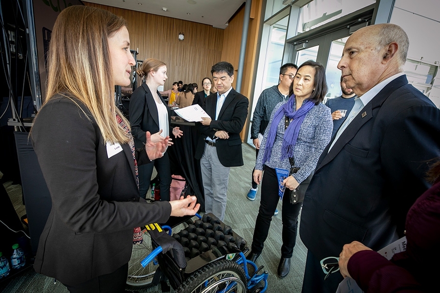 Loop team members Sarah Tress (left) and Shannon McCoy (second from left), both juniors in mechanical engineering at MIT, explain to attendees their wheelchair cushion made of readily available and inexpensive bicycle inner tubes that aims to prevent pressure sores. The team took home a ,500 prize from the competition for their invention.