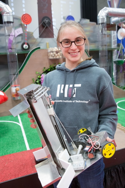 Mechanical engineering sophomore Elizabeth Pedlow shows off the robot she built in class 2.007 at the final robot competition. 